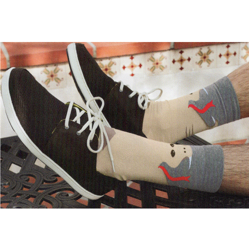 This Model is wearing the K Bell Mens Snake Sock with Black Shoes. Showing the Grey top of the Sock and the Sand color of the Snake with white Fangs and Red Tongue.