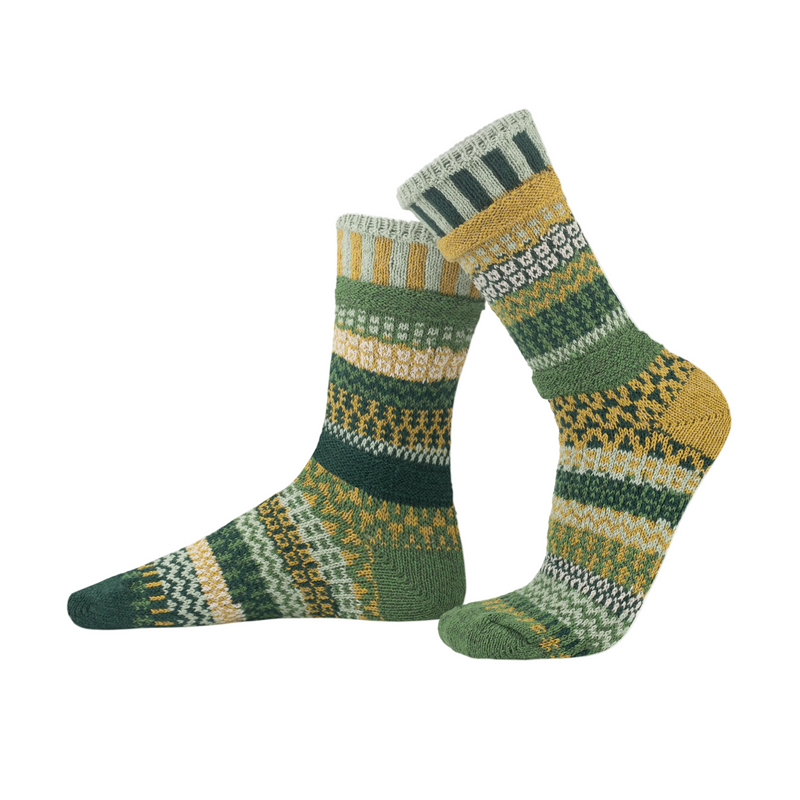Solmate Sock Mismatched with Geometric Shapes in Greens Bone and Blue on White background.