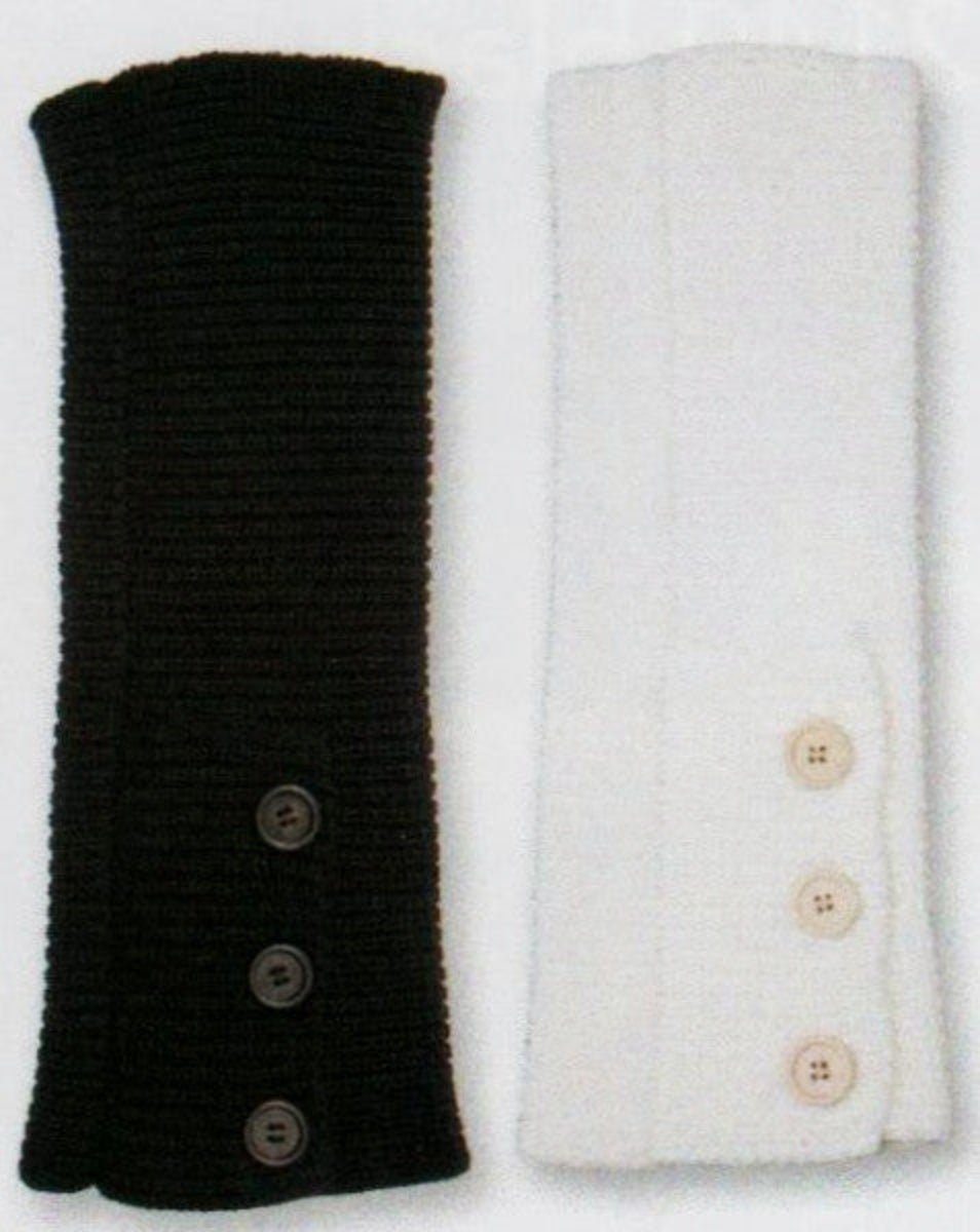 A pair of K Bell 3 Button Leg Warmers, one in black and one in white, laid out flat with button closures visible.