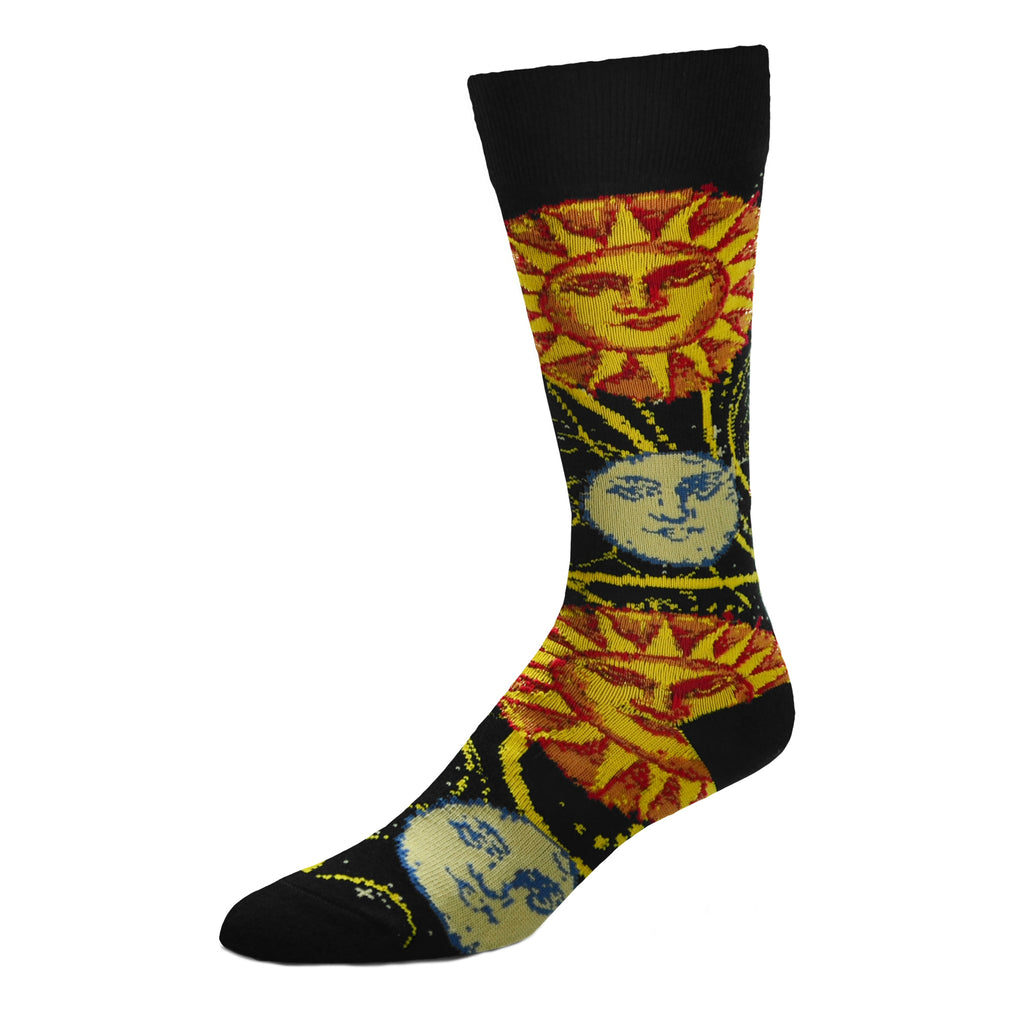 For Bare Feet Sun and Moon Sock begins on a Black background. The Cuffs, Heels and Toes are all solid Black. The Sun has a Face in the Center. Around the Circle are Flames and behind those are the gases. The Solar Flares are flying off the Sun all around the Sock. It even goes over The Man in the Moon's Face. The Moon looks pleasant in the rays of the Sun.