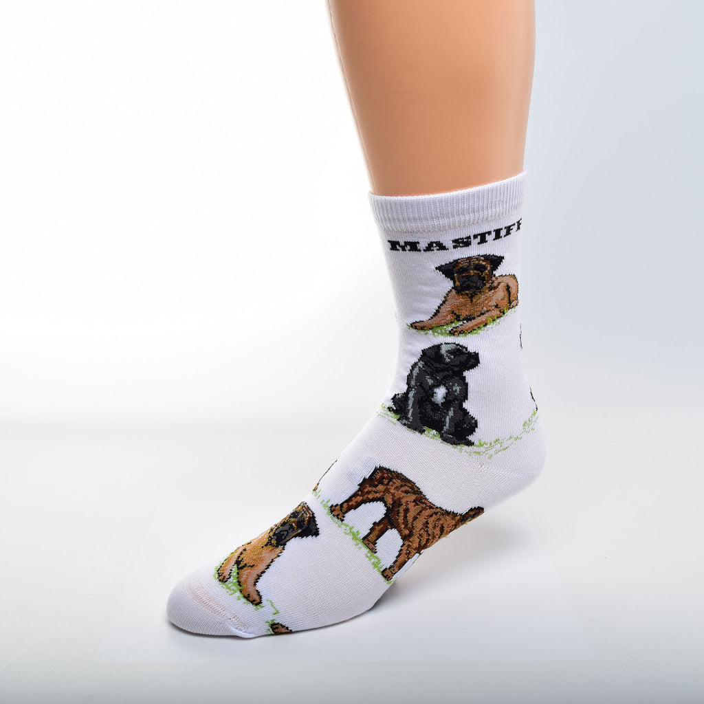 For Bare Feet Mastiff Poses Sock has a White background. Mastiff, is in Bold Black Print under the Cuff. The Poses are on Green Grass. The first Pose is an Apricot with Black Mask Mastiff Laying Down. Then a Black Mastiff with White Markings Sitting. A Brindle Mastiff in a Stance is the Last and the pattern begins to repeat.