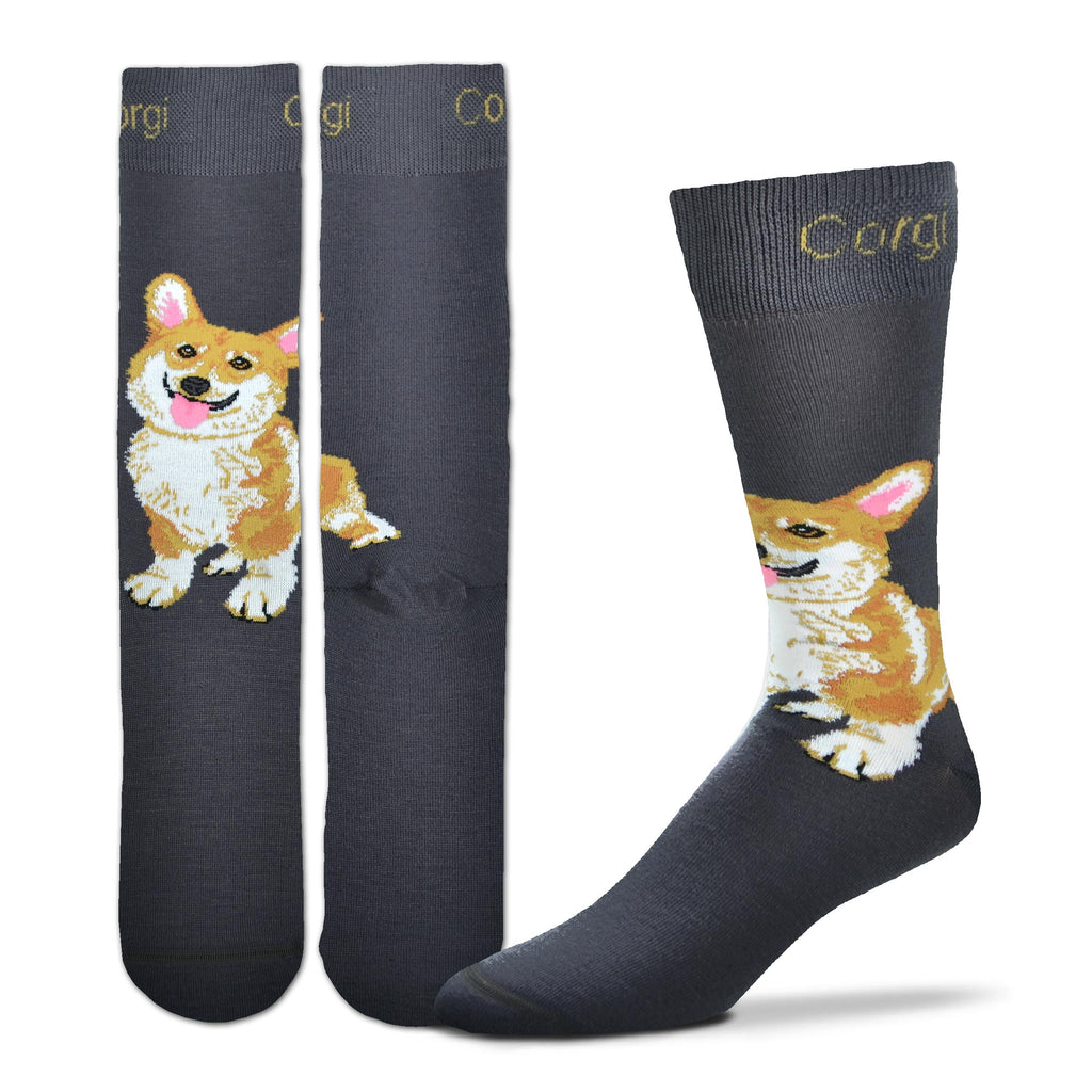 FBF Realistic Corgi Sock starts on a Charcoal background. On the Cuff reads "Corgi". The Corgi sits with a Happy Face on the Top of the Foot looking out. Sitting on Her back legs, front legs forward. She is White and Buff with Rust. Her Face is White, Buff,and Rust with Black for Eyes, Nose and Mouth. Eyes are Russet inside. The Ears and Tongue are One Tone Rose.