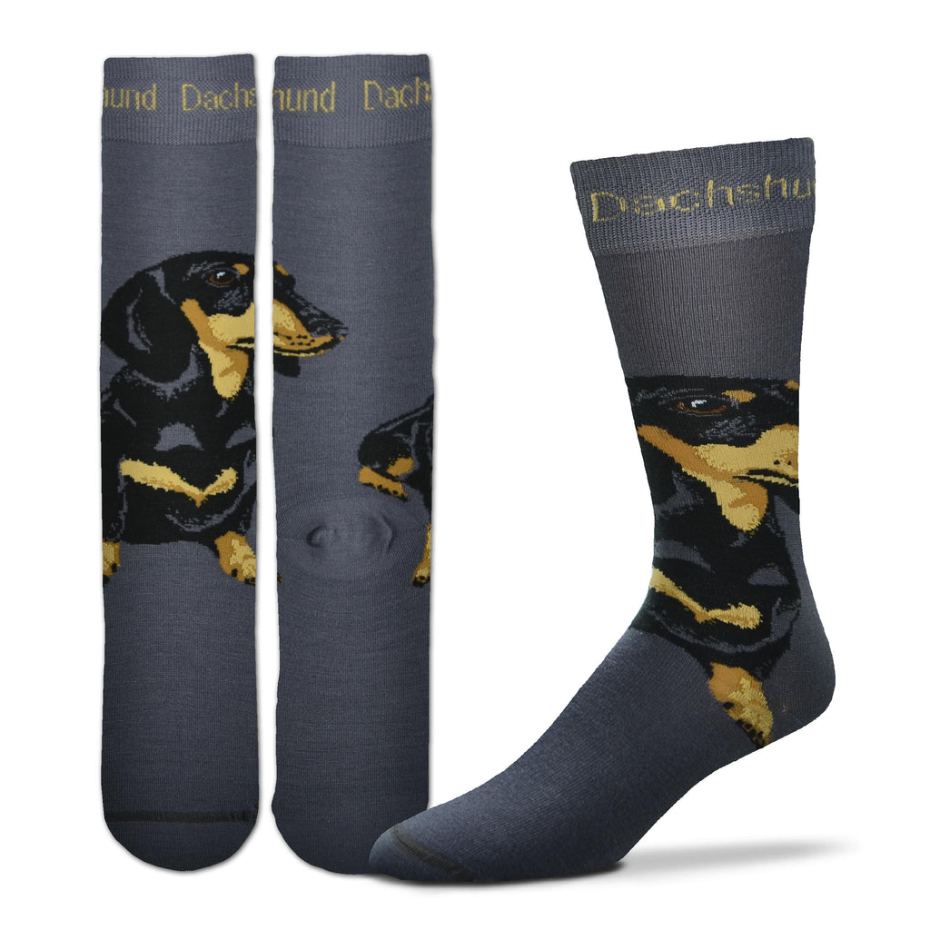 FBF Originals Realistic Dachshund Sock starts on a Charcoal backdrop. The Cuff has Dachshund written in Buff. The Dachshund is sitting on Top of your Foot. It is Black Masked with Seal Brown Eyes. Buff markings on his Cheeks along with Russet shades and Charcoal. These travel down the Dachshund Chest and Feet.