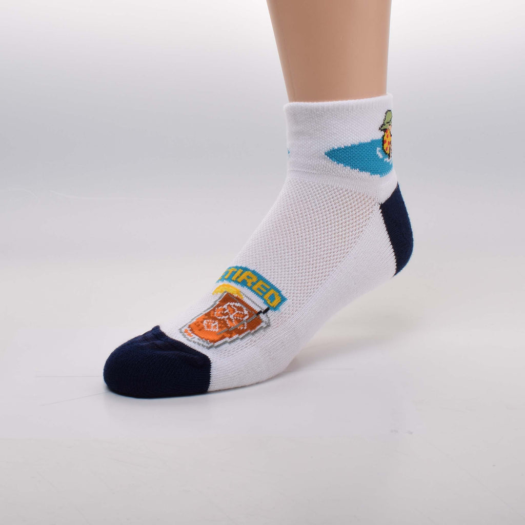 For Bare Feet Retired Guy Sock starts on a White background with Navy Blue Cushioned Heels and Toes. The White Bottom Soles are also Cushioned for this Sport Speciality Sock. The Cuff has a Retired Guy with a Green Bucket Hat on a Yellow and Red Inflatable Raft in a Blue Pool. Wearing Red Trunks he is holding a drink. On top of the Foot is a Large Drink Graphic in Brown and Orange with a banner that reads Retired.