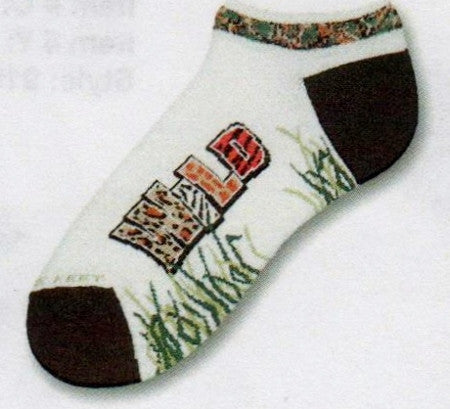 FBF Wild No Show Sock has a Jungle Motif on the Cuff. Heels and Toes are Black. Wild is written on the Foot in many animal prints. Tall grass comes up from the instep towards the side of the feet.