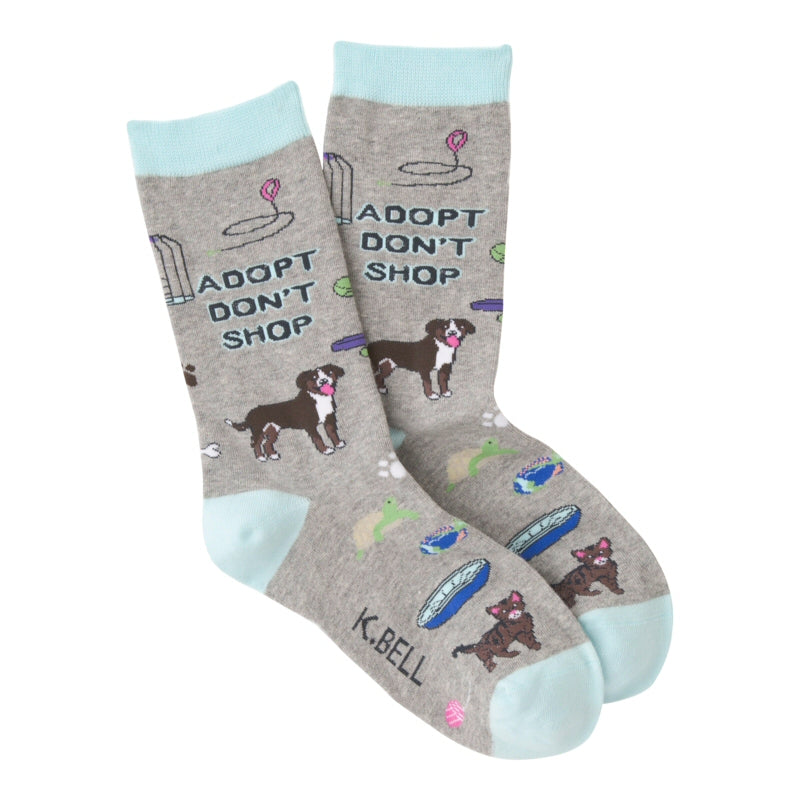 K Bell Adopt Me Sock begins on a Grey Heather background with Aquamarine Cuffs, Heels and Toes. Under the Cuff reads "ADOPT DON'T SHOP". There are leashes, bird cage with a Bird a Dog and a Bed a Cat  and A Turtle with lots of other things around the Sock.