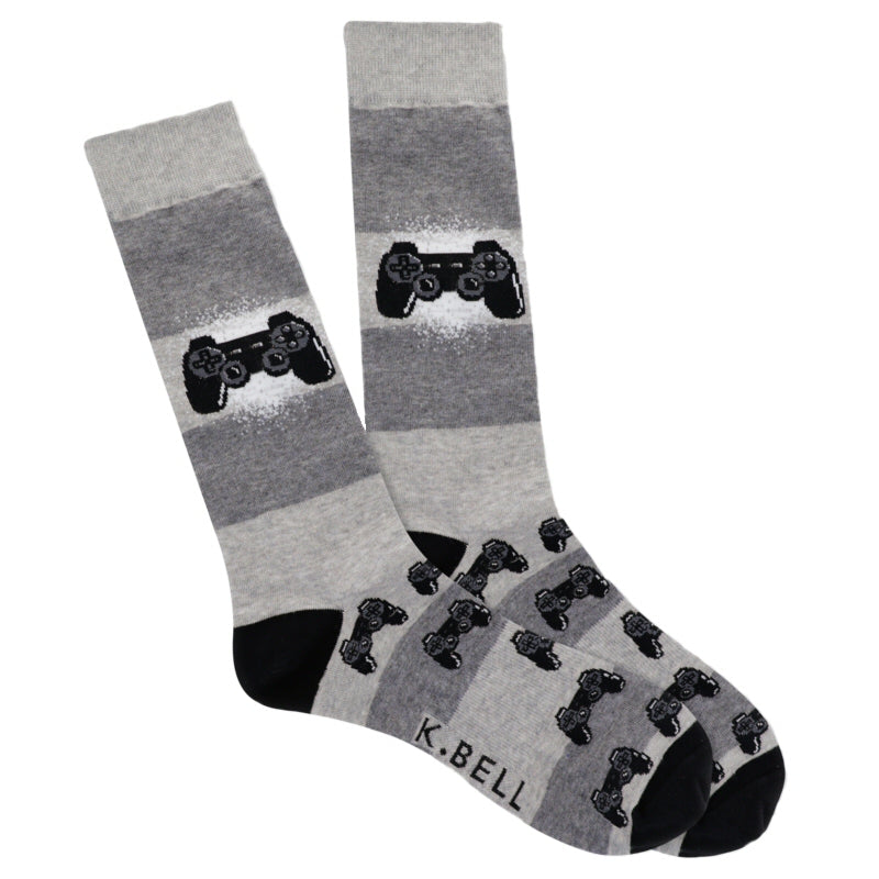 K Bell Mens Born to Game Sock is an easy Sock to wear and just show off a little bit about yourself to others maybe at work. Starting on a Heather Grey background with Black Heels and Toes the Sock also has Charcoal Grey. Midway down is one Controller in a bit of White splashed behind it.  Then the pattern gathers up stacks of Controllers at the Heel moving down to the Toe.