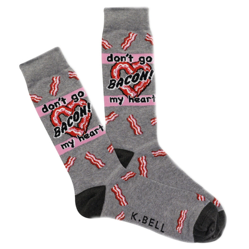 K Bell Mens Bacon My Heart Sock starts with a Charcoal Heather background with Onyx Toes and Heels. All around the sock are Red, White and Candy Pink Strips of Bacon from Cuff to Toes. Under the Cuff at the mid Ankle is a Heart made out of Bacon Strips. In Candy Pink Rows Top and Below are words, the Top says, "don't go" then across the Heart is "BACON!"  then again on Candy Pink Below says "my heart"