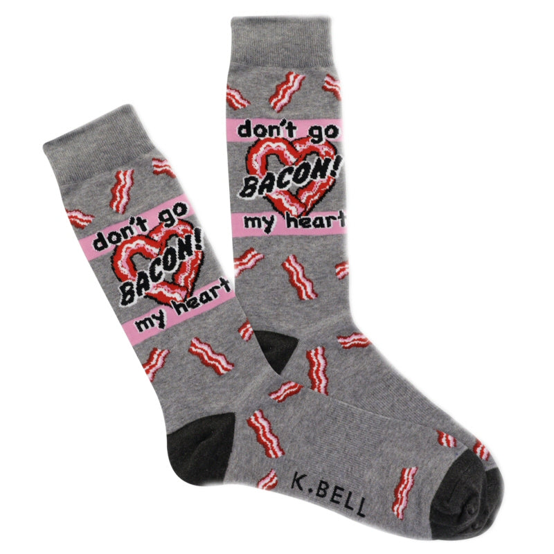 K Bell Mens Bacon My Heart Sock starts with a Charcoal Heather background with Onyx Toes and Heels. All around the sock are Red, White and Candy Pink Strips of Bacon from Cuff to Toes. Under the Cuff at the mid Ankle is a Heart made out of Bacon Strips. In Candy Pink Rows Top and Below are words, the Top says, "don't go" then across the Heart is "BACON!" then again on Candy Pink Below says "my heart"