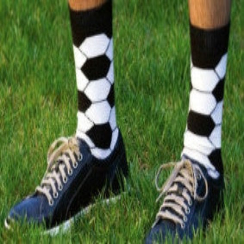 Play Soccer while in Soccer Ball Socks by K Bell. Black background with White and Black making the pattern of a Soccer Ball on a Model