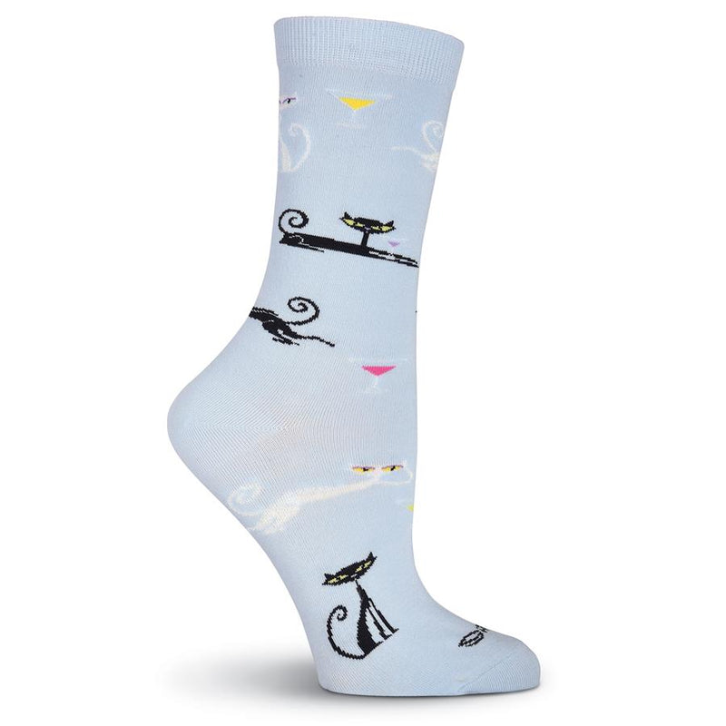K Bell Womens Shag Cats Sock starts on a Light Blue background with White and Black Cats Lounging and Sitting. They are drinking from Martini Glasses.