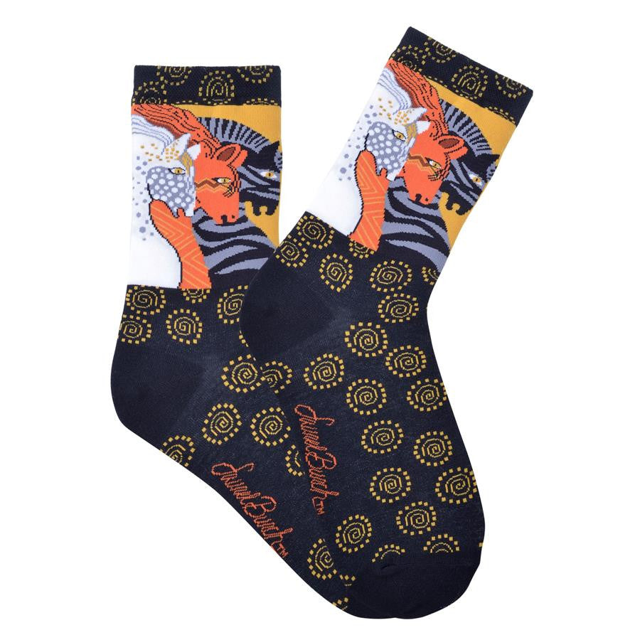 Laurel Burch Moroccan Horses Socks are on Burnt Orange and Black backgrounds. The Foot is all Black with Burnt Orange Circles and Swirls. The Horse appear to be running. Black and Grey, Cinnabar and White.