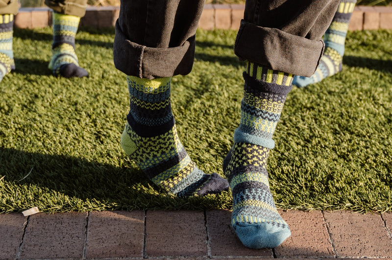Solmate Adult Crew Lemongrass Sock on Models on lawn grass.