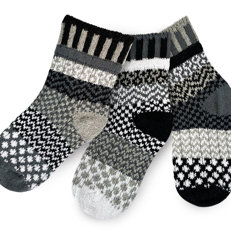 Solmate Kids Crew Moonlight Socks come in a Pair with a Spare. Colors are Black, Grey and White lines and shapes.