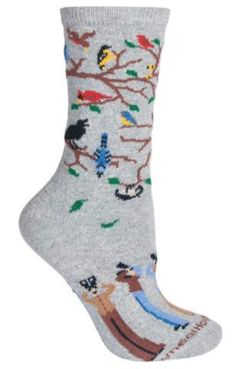 Wheel House Designs Birdwatchers on Grey Sock have Birds in a fall season tree with Green Leaves falling down. The Brown branches are bare better to see all the Birds in the Tree and in the Air. The Birds appear to be Cardinals, Goldfinch, Blue Jays, Crows and Mourning Doves. Below the Heal are Men and Women with Field Glasses watching the birds above.