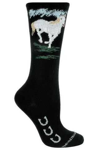 Wheel House Designs White Horse Sock starts with a Black background. On the Foot on each side are 3 Horse Shoes turned up for Good Luck. On top of the Sock is a White Horse Galloping over Green Grass. 