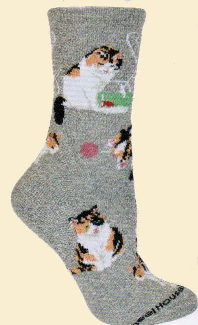 Calico Cats on a Grey background. One playing with a fish in bowl, one with a ball. Plus more.