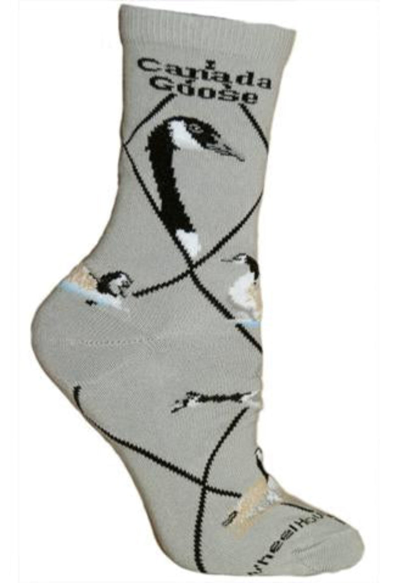 Wheel House Designs Canada Goose starts on a Grey background with Black Argyle lines. Canada Goose reads on sock below cuff. Two profiles are next of Canada Goose showing long beak black Face, long Black Neck and White Chin Strap. Below are poses of in flight, coming in for landing in water, resting in water, sleeping on ground and nesting.