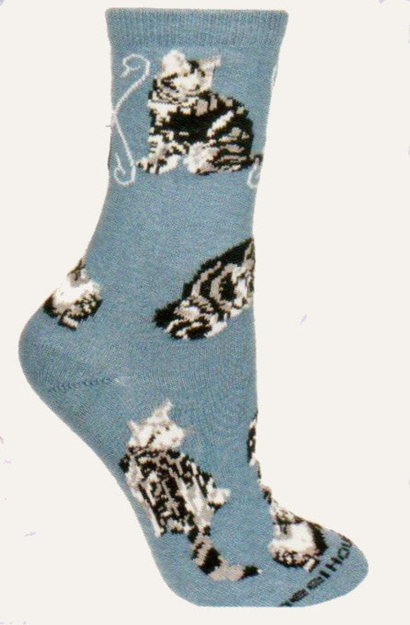 Wheel House Designs Silver Tabby on Blue has Poses of Cats that are mostly Black and White in color. They surround the Sock.