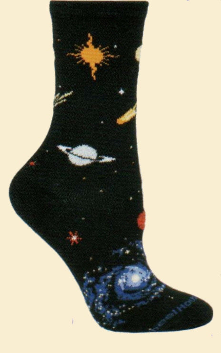 On a Black background Items in Space are woven in, a Sun and Moon some Stars. Comets are flying by a Ringed Planet and a Spiral Galaxy at the Toes.