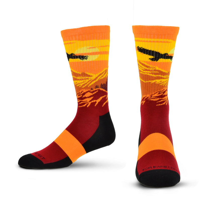 Colorful socks with sunset and eagle design on a white background