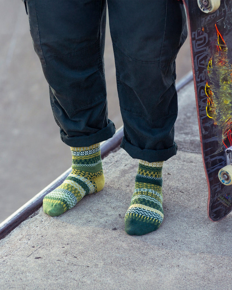 Solmate Fiddlehead Sock on a Model with a Skateboard