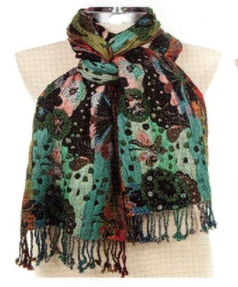 A multicolor patterned scarf with fringe, displayed on a beige fabric mannequin torso against a white background.