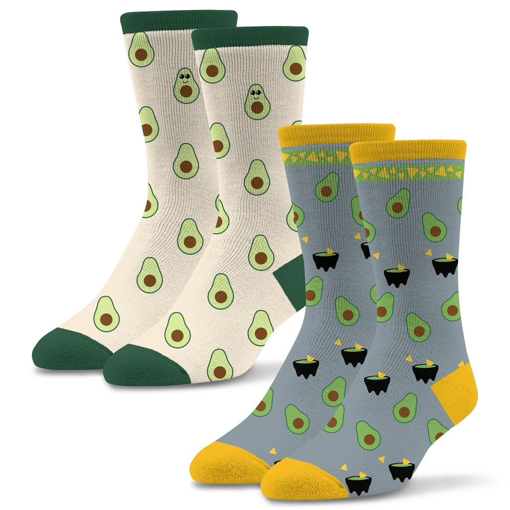 Socktastic 2Pk Avocado Socks has one Sock of Avocados all over an Almond background.  One Avocado has a face with a smile. The other sock has a Grey background with a bowl of chips  with Guac and Avocados.