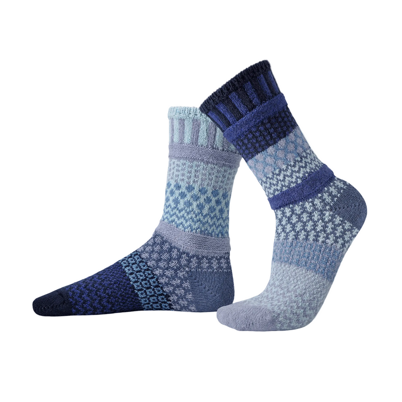 Pair of dark blue and light blue patterned socks on a white background