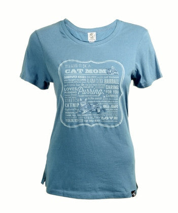 Cat Mom in Blue Scooped Neck Line with a Picture of a Cat in the Middle of the Shirt and on the Top Left side is a Facial of a Cat.. All over are sayings about Cats.