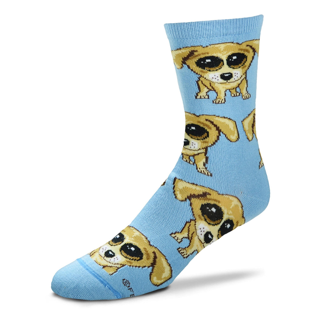 For Bare Feet Dogs Jumbo Eyes Sock starts on a Light Blue background. The Dogs have Jumbo Black and White Eyes. The Dogs are Colors of Browns, Camel, Buff, and Seal Brown. 
