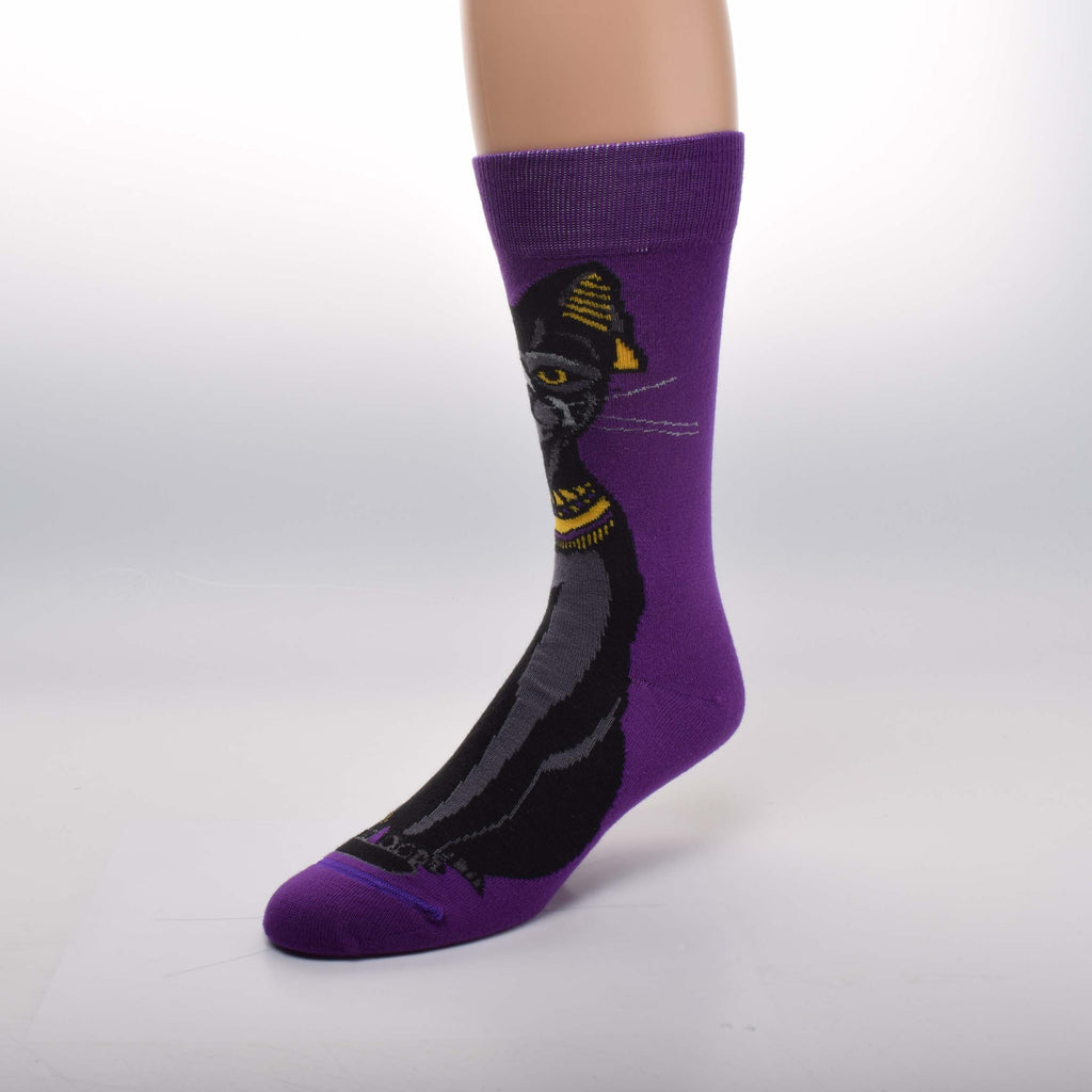 For Bare Feet Egyptian Cat Sock starts on a Purple background with a Beautiful Black Cat staring at you with Amber Eyes. She has Gold jewelry on her head and neck and around her foot.