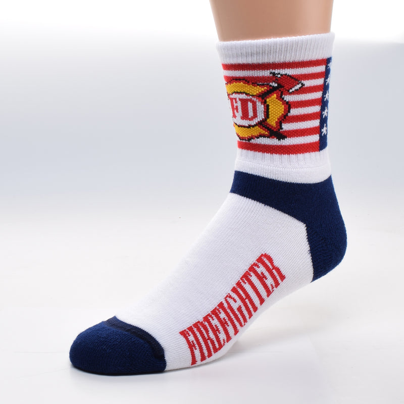 For Bare Feet Firefighter Flag Cuff Sock is an American Flag on the Cuff with a Firefighter Badge superimposed on top. The Foot of the Sock has Navy Blue Heels and Toes and Red Firefighter reads on both sides in a field of White.