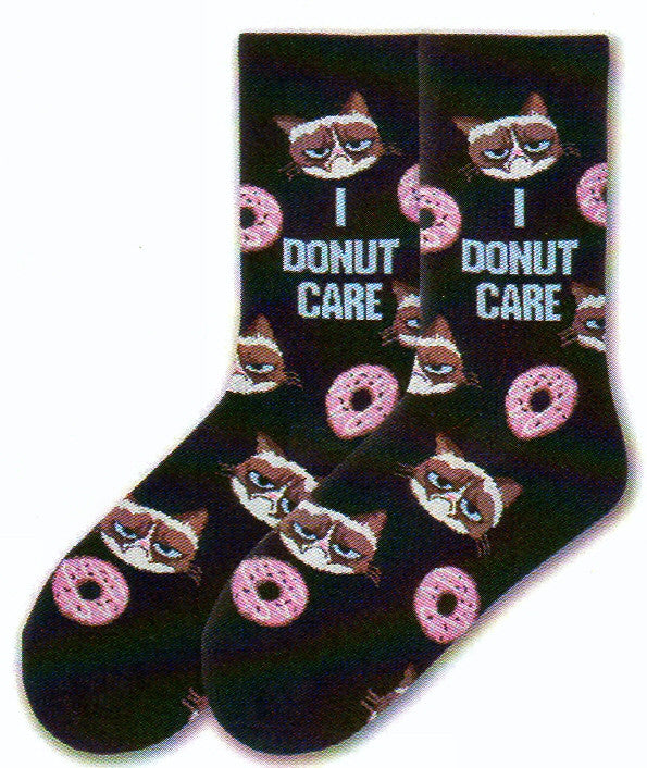 K Bell Womens Grumpy Cat I Donut Care Sock is on a Black background with Grumpy Cat and Pink Donuts exchanging rows. In the Middle in Blue reads, "I Donut Care"