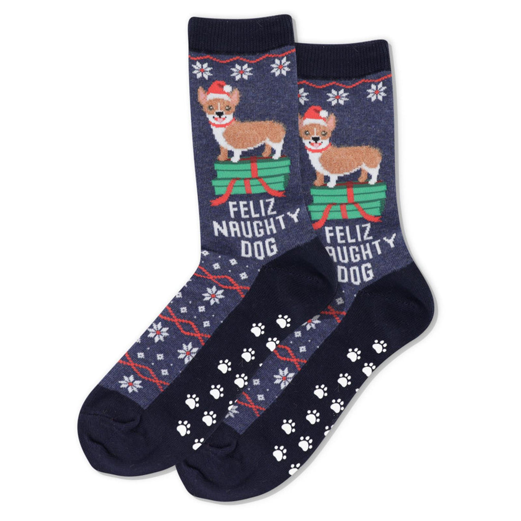 Hot Sox Womens Feliz Naughty Dog Non Skid Socks shows a Happy Corgi standing on Presents. He seems to be unwrapping. "Feliz Naughty Dog" underneath! Non Skids are Paw Tracks!