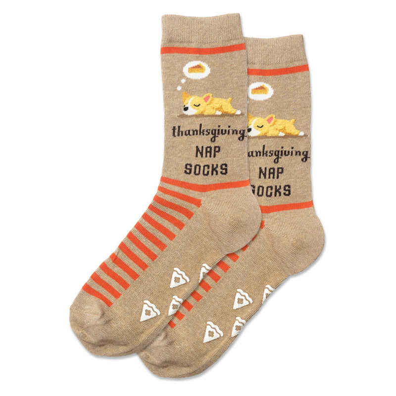 Hot Sox Womens Dog Pie Nap Non Skid Socks are on Beige with Orange Stripes. The Dog is napping and dreaming of Pumpkin Pie.  Under the Dog it says. Thanksgiving Nap Socks.  The Non Skid look like Pie Slices.