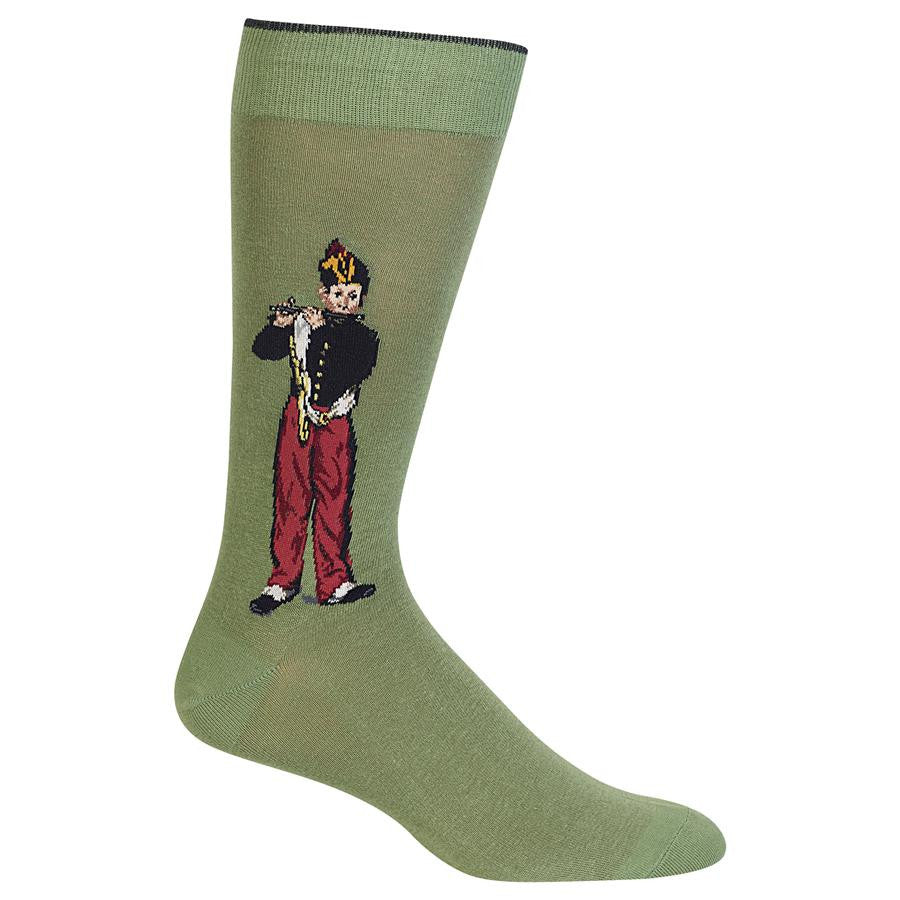 Hot Sox The Fifer Sock is in the Great Artist Sock Collection and begins with a Moss Green background. The Fifer is a Boy dressed in a Black Coat, Red Pants and Black Shoes. He is standing playing his Coal Fife.