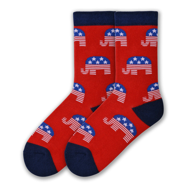 K Bell Womens American Made Republican Socks start off with a Red background. It has Blue Cuffs, Heels and Toes. The Elephants are Blue with White Stars on their backs and Red and White Stripes through the Trunk and Feet.