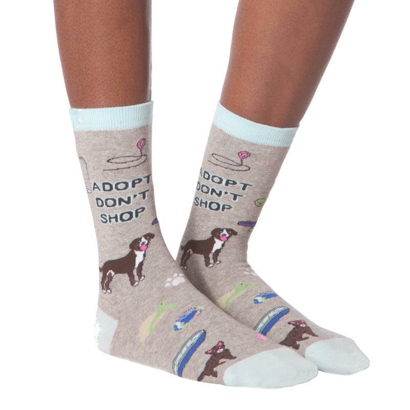 K Bell Adopt Me Sock says quite clearly Adopt Don't Shop for Animals. There are plenty of animals in shelters and Rescues all over the United States and the World needing new homes. Dogs, Cats, Birds and Turtles with toys and tools are on this Sock worn by a Model.
