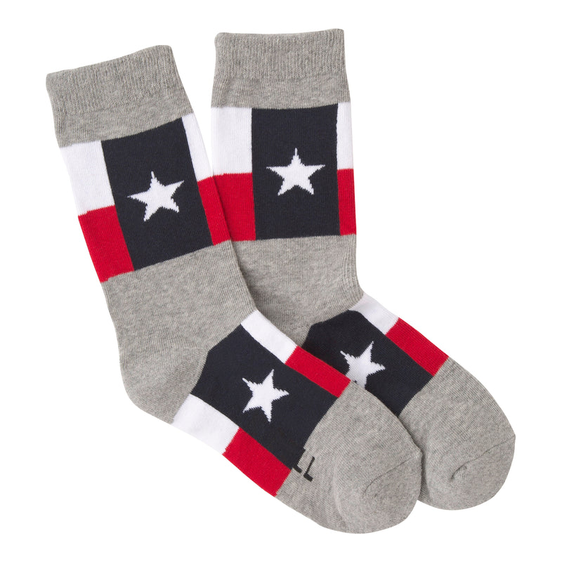 K Bell American Made Texas Flag for Women starts on a background of Grey. Under the Cuff starts the Lonestar Flag.  The Blue Bar runs Vertical with the Lone White 5 Star in the Middle. The White Bar On Top and the Red Bar are Horizontal to the Blue Bar.  The Texas Flag then repeats on the Arch of the Sock.