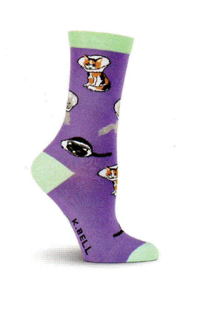 K Bell Cone Cats Socks begins on a Purple background with a  Medium Aquamarine for Cuffs, Heels and Toes.  The Cats are Calico Cats,  Greys and Blacks. For whatever reason the poor kitties are wearing Cones. 