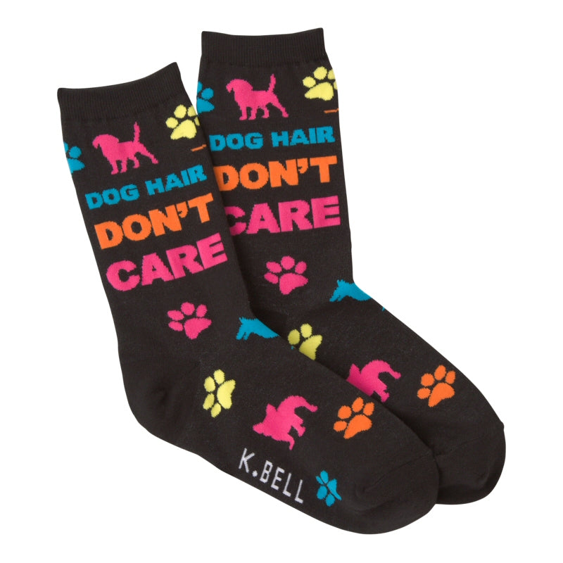 K Bell Dog Hair Don't Care Sock has this phrase written at the Top of the Sock under the Cuff.  Right Below the Cuff is a Bright Fuchsia Silhouette of a Dog and some Blue and Yellow Paw Prints.  Dog Hair is written in Cyan, Don't is in Orange and Care is in Fuchsia. Other Paw Prints are in Fuchsia and Orange and a Silhouette is in Cyan too. All are on a Black background.