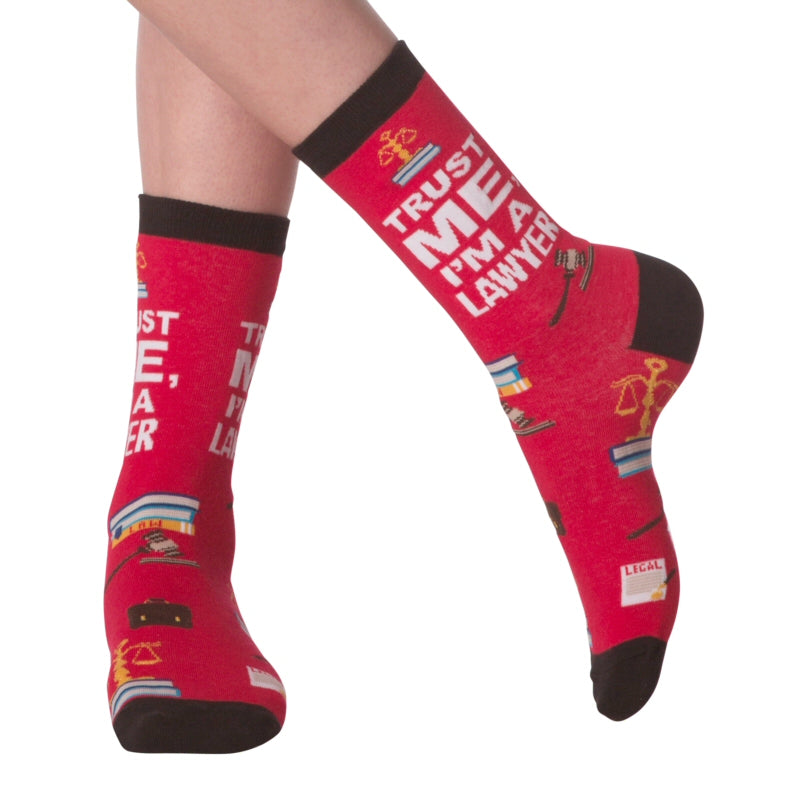 K Bell I'm A Lawyer Sock on a Model shows the Sock front and side views. In Red with Black Cuffs, Heels and Toes. It also shows som of the things a Lawyer might see and use. It says, Trust Me, I'm A Lawyer"