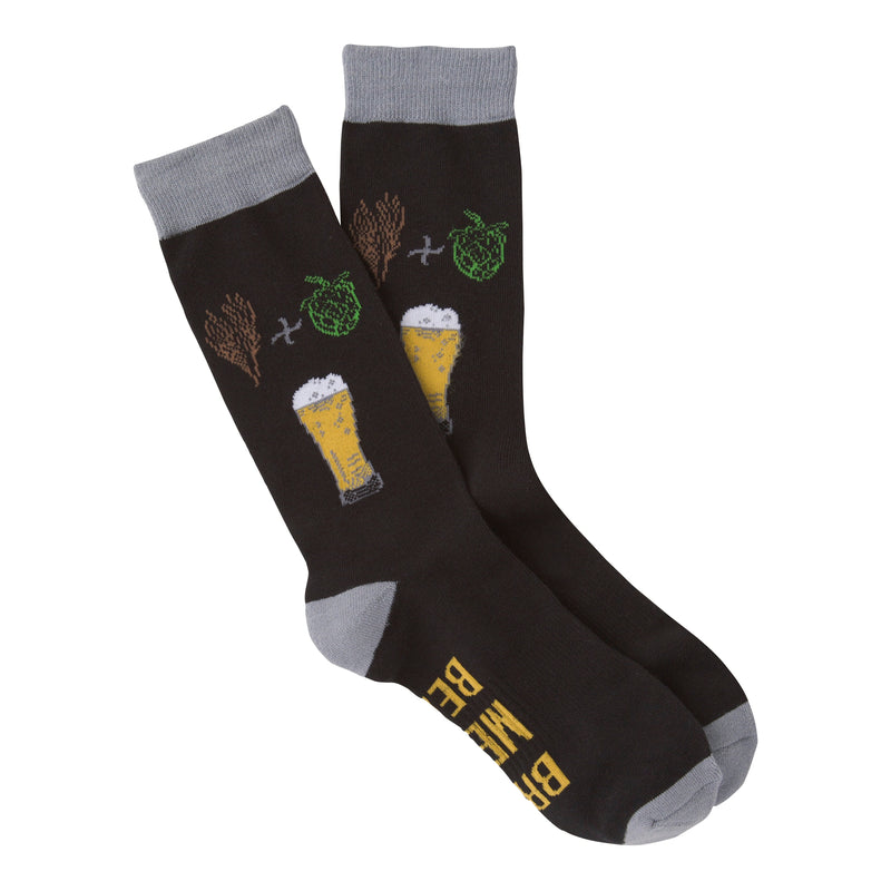 This is K Bell American Made Mens Beer Sock. It is a Large Size that starts on a background of Black. The Cuffs, Heels and Toes are Charcoal Grey. Below the Cuff are a Sprig of Barely a Plus Sign and Hops to make the Beer below. The Beer in the Glass is Golden with White Foam on Top. In the Arch of the foot reads, "Bring Me A Beer" in Golden Text.