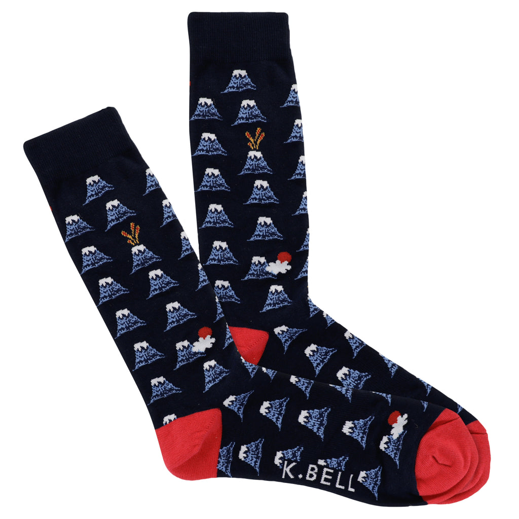 K Bell Mens Volcanoes Socks starts on Navy with Heels and Toes Red. Volcanoes all over a few active. A few with Clouds and Sun.