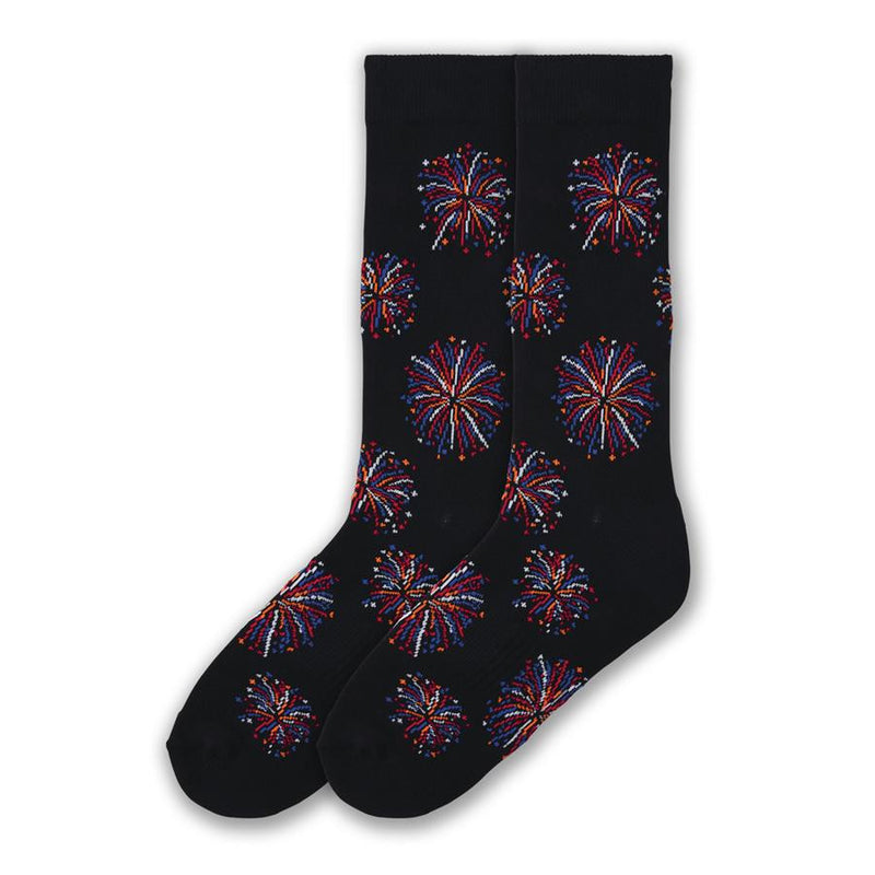 K Bell American Made Mens Fireworks Sock begins on a Black background with Flower Patterned Fireworks in Red, Blue, Orange and White