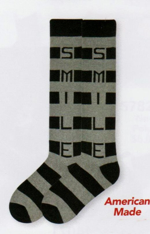 K Bell Recycled Cotton Smile Stripe Knee High Sock is made with Medium Heather and Black Rows of Stripes. Going down the side of the Sock is the word in Capital Letters, SMILE.