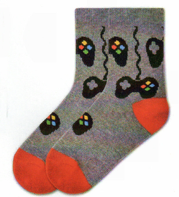 K Bell Boys Controls Sock starts on a Charcoal Heather background. The Heels and Toes are Bright Red. Game Controllers are the Controls on this sock. They are wired and wireless. On the Right Side are the 4 Buttons, Yellow, Blue, Red and Green. On the Left Side is the Grey D-Pad.