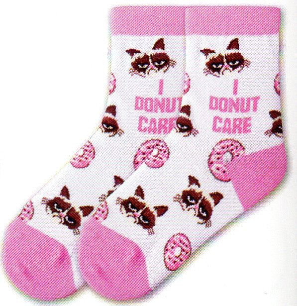 K Bell Kids Grumpy Cat I Donut Care Sock comes in a White background with Pink Cuffs, Heels and Toes. Grumpy Cat has his picture interchanged in rows with Pink Iced Donuts. In the middle of the Sock is the Meme that says, "I Donut Care".