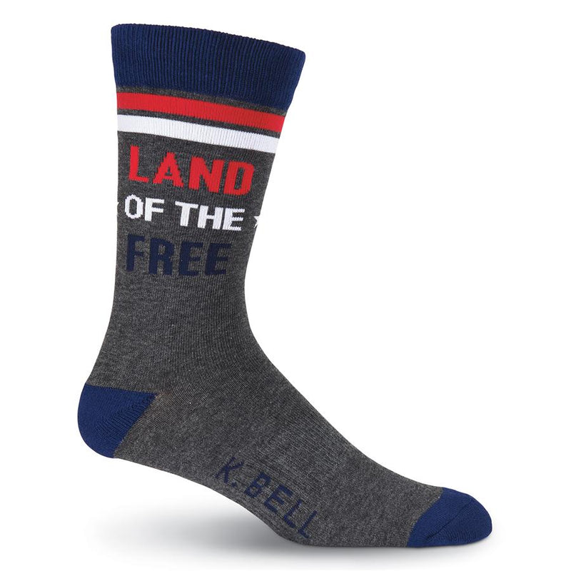This is the Large Sock it begins on a Medium Grey background. The Cuff is Navy Blue then there are two stripes one of Red and one of White. The Heels and Toes are Navy. In the middle of the Leg reads, "Land of The Free".